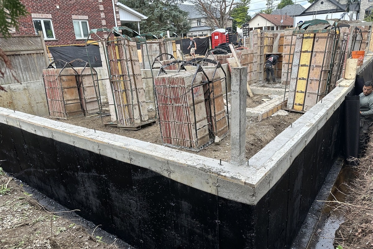 Foundation walls and reinforced concrete columns during early construction stage.