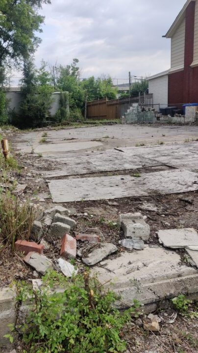 Existing lot condition before construction — cleared pad with neighbouring houses