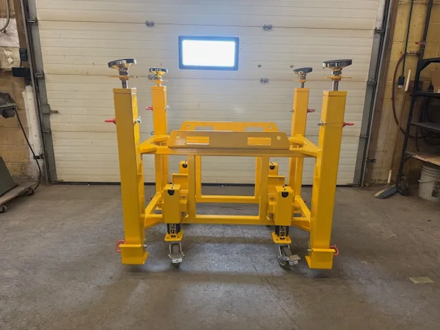 Yellow steel bogie support stand under stability review in a workshop